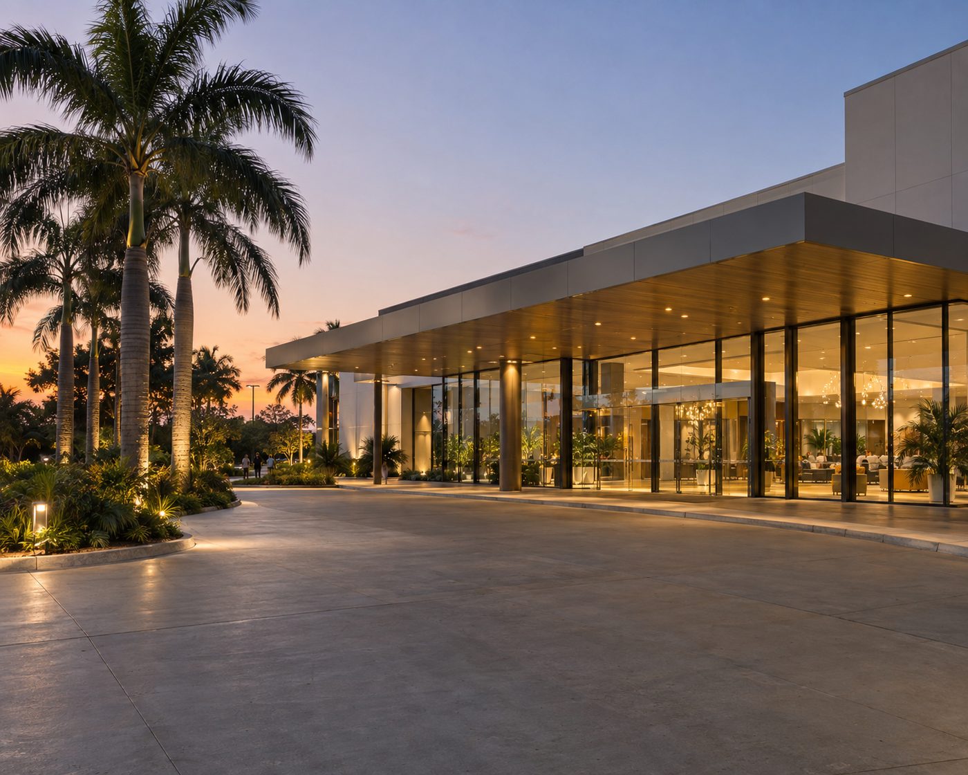 The set down area outside a glass conference centre at dusk