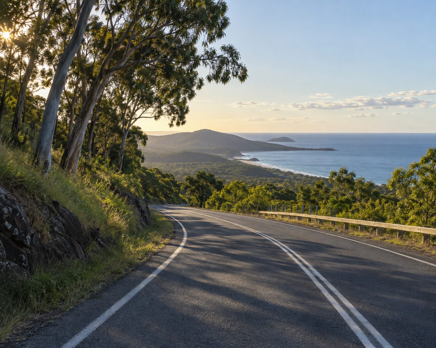 A quiet coastal road between green hills and the ocean in the Northern Rivers